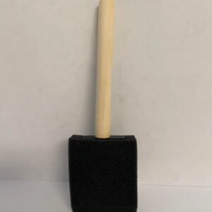 A black foam brush with a wooden handle