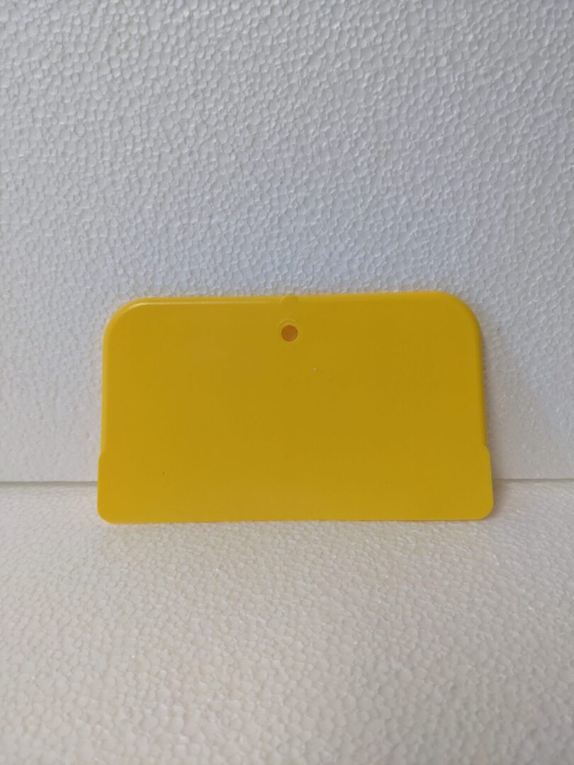 A basic plastic paint scraper