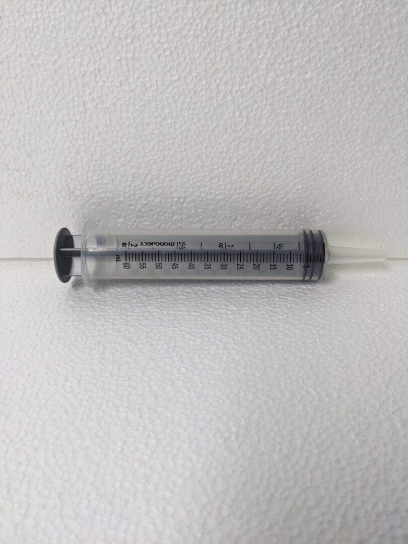 A plastic plunger style syringe